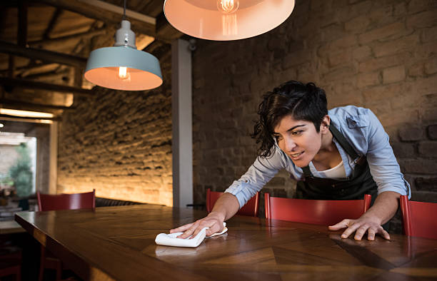 Waitress cleaning a table at a restaurant