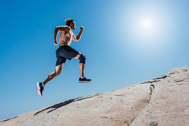 istock Male Running Up A Granite Boulder In The Mountains 527896836