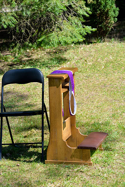 Sacrament of penance Kneeler and chair preparation for the Sacrament of Reconciliation and Penance missing priest kneelers stock pictures, royalty-free photos & images