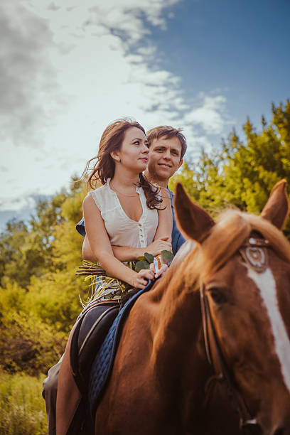 istock Young beautiful couple  with a horse. Filtered. Selective focus. 527899792