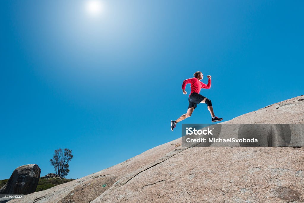 Male Running Up A Granite Boulder In The Mountains Running Stock Photo Male Running Up A Granite Boulder In The Mountains Running Stock Photo
