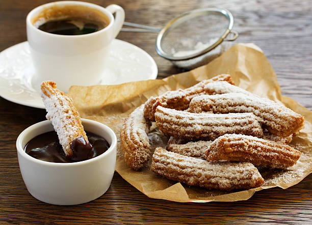 istock Churros with hot chocolate and powdered sugar. 527901722