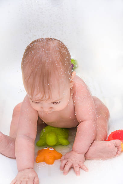 istock baby playing with toys in bathroom during shower 527901896