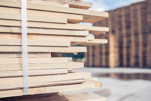 Stacks of wooden pallets and wood for production.