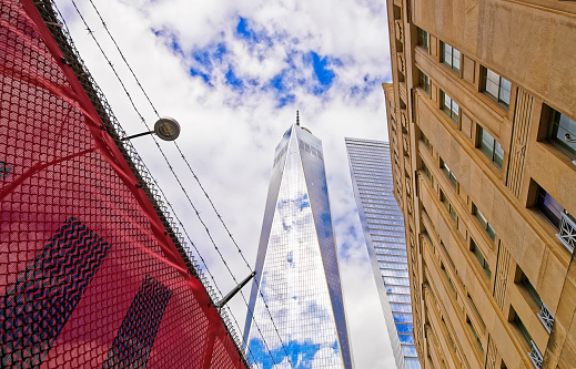 New York, USA - April 24, 2015: View of One World Trade Center and barbed wire in Lower Manhattan, New York City, USA. It is One WTC in short, or Freedom Tower