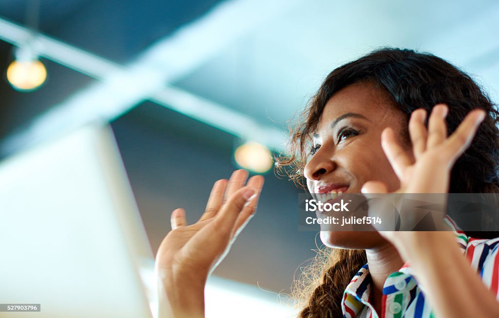 Candid image of succesful business african american caught in an Portrait of casual female employee participating in a project during a team brainstorming Candid Stock Photo