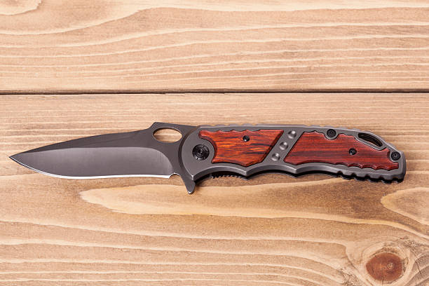 istock Folding knife  on a wooden background 527904022