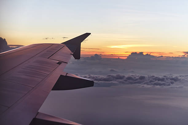 istock flying aircraft wing on beautiful sunset 527905228