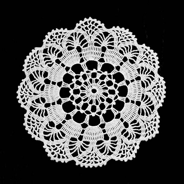 Lace doily isolated on black background Lace doily isolated on black background lace doily crochet craft product stock pictures, royalty-free photos & images