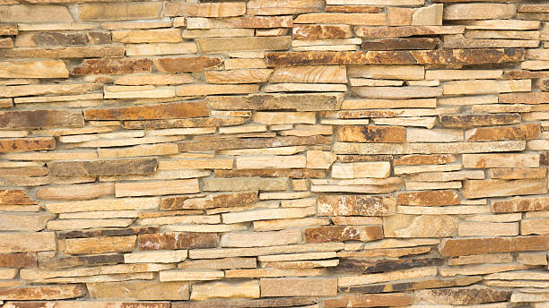istock wall of a wild yellow decorative stone 527908290