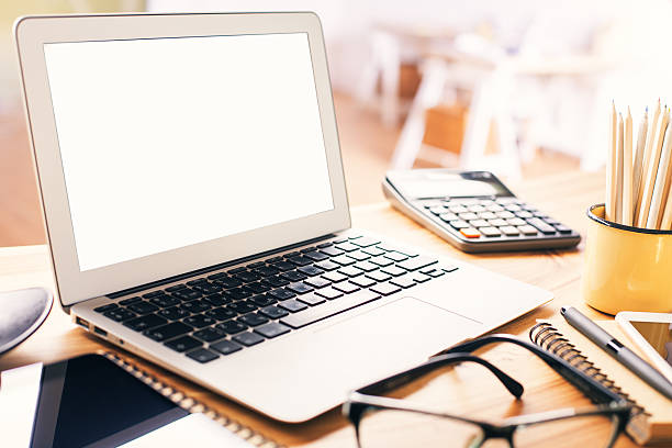 Blank white laptop screen Closeup of blank white laptop screen on office desktop. Mock up ipad calculator stock pictures, royalty-free photos & images