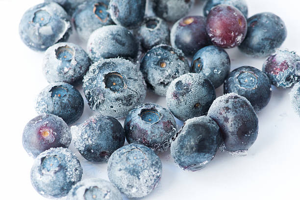 Frozen blueberries isolated on white stock photo