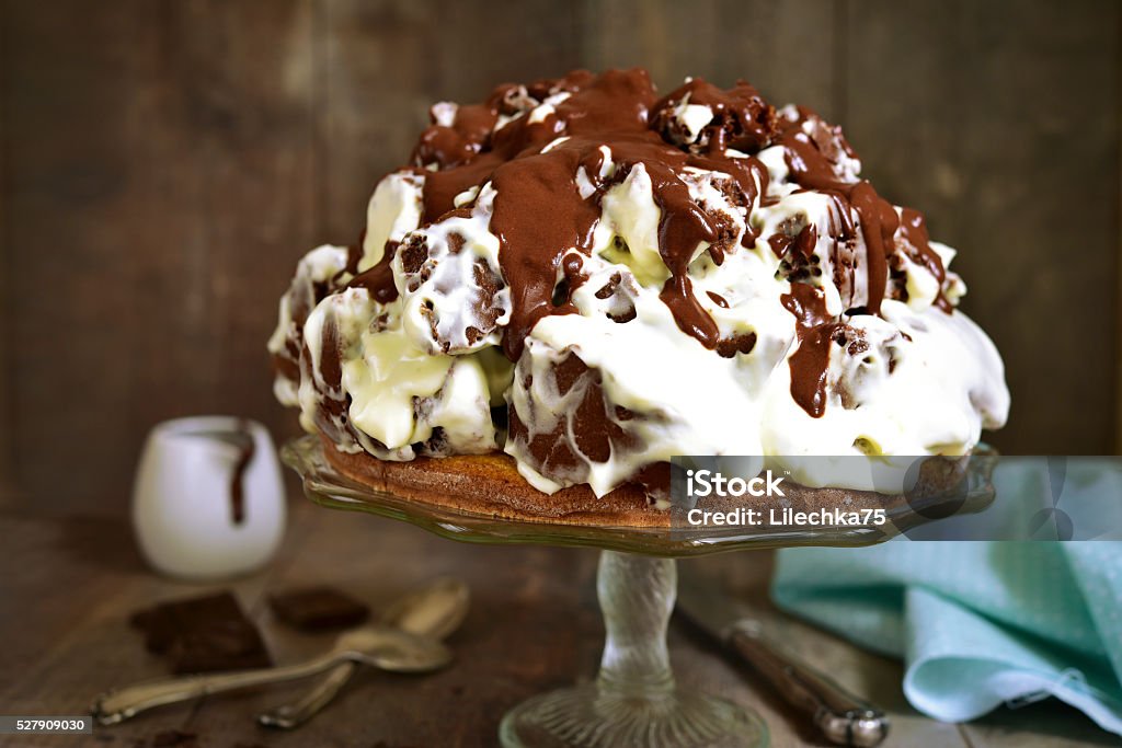 Chocolate cake with sour cream and chocolate glaze. Chocolate cake with sour cream and chocolate glaze on a rustic wooden background. Almond Stock Photo