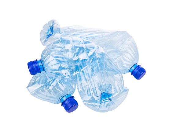 istock Mineral water bottles crushed and crumpled against white backgro 527910762