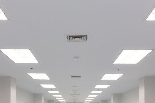 ceiling and fluorescent lighting with exhaust fan louver smoke detection and fire water sprinkler, selective focus
