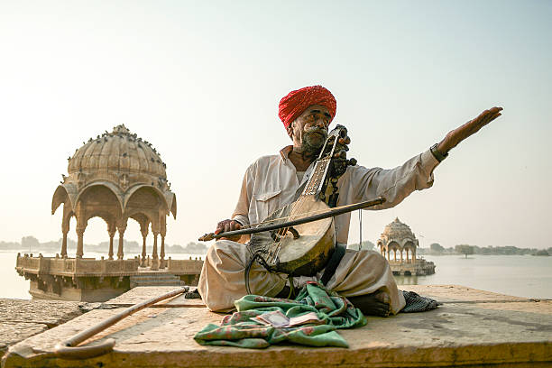 nomads plays kamaycha in the Ghadisar Lake in Jaisalmer, India Jaisalmer, India- November 24, 2015:Unidentified nomads plays kamaycha in the Ghadisar Lake in Jaisalmer, India. Kamatcha is an ancient instrument used by traditional folk singers in India. rajasthan stock pictures, royalty-free photos & images