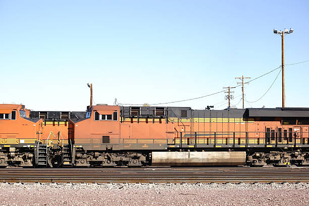 A General Electric Dash 9 stands with cargo on a train yard in the desert in Needles.