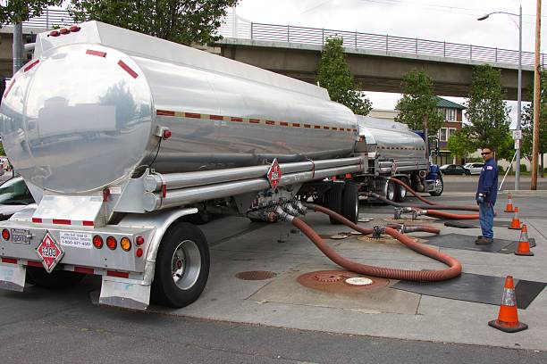 American truck-tanker merges gasoline at a gas station Milpitas, California, United States - April 21, 2016. American truck-tanker merges gasoline at a gas station (back view).  fuel truck photos stock pictures, royalty-free photos & images
