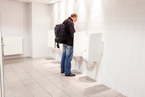 urinals in an old building for men only
