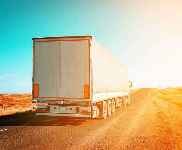 istock freight truck driving to sunset 527955587