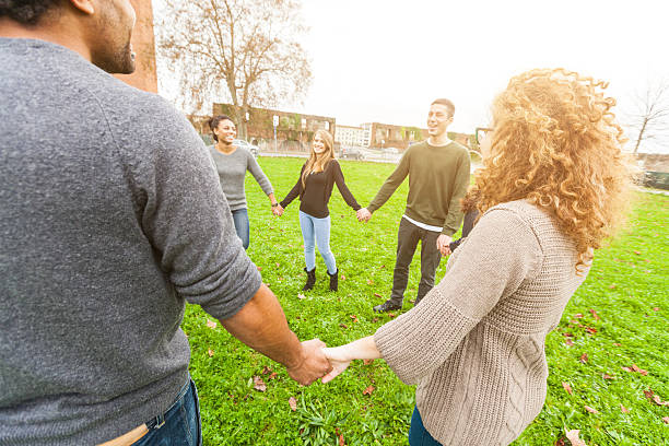 istock Multiethnic Group of Friends Holding Hands in a Circle 527959203