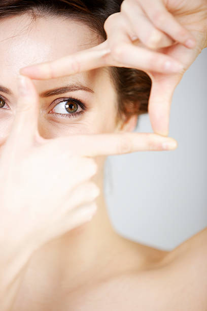 istock Woman peering though her fingers 527959435