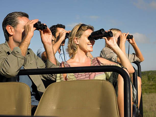 istock Tourists In Jeep Looking Through Binoculars 527959937