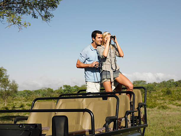 istock Couple With Woman Looking Through Binoculars In Jeep 527959947