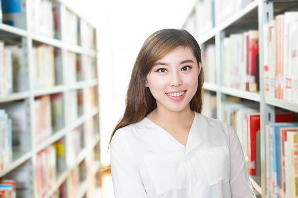 istock young beautiful asian girl university student in library 528042062