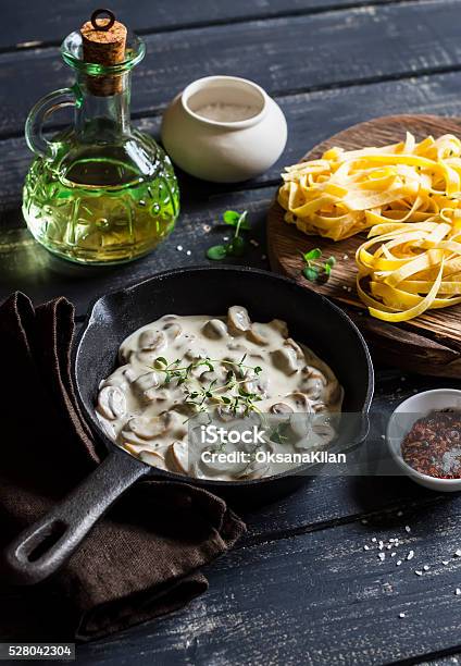 Ingredients For Cooking Pasta With Creamy Mushroom Sauce Stock Photo - Download Image Now