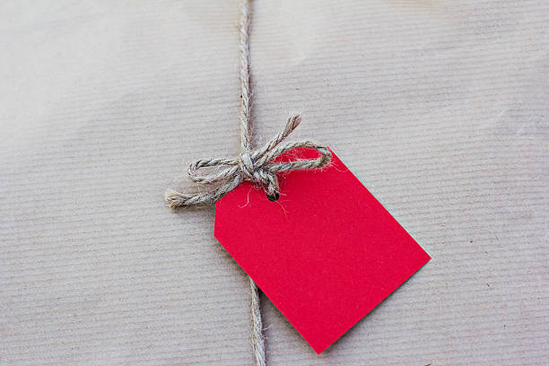 istock gift in kraft paper with red card 528042546