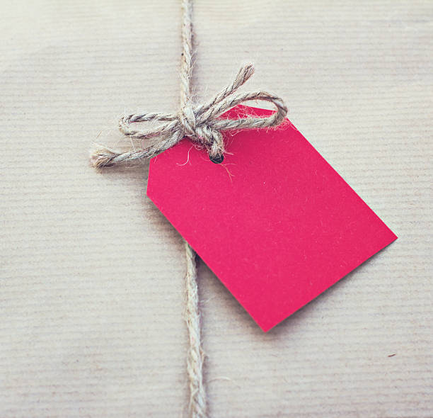 istock gift in kraft paper with red card 528042932