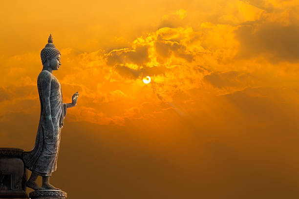Buddha statue with sun Big Buddha statue on sunset sky buddha photos stock pictures, royalty-free photos & images