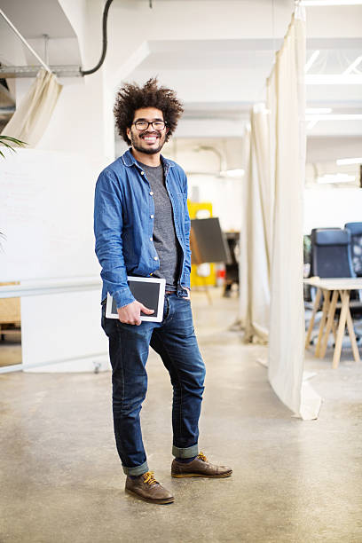 Confident businessman holding digital tablet