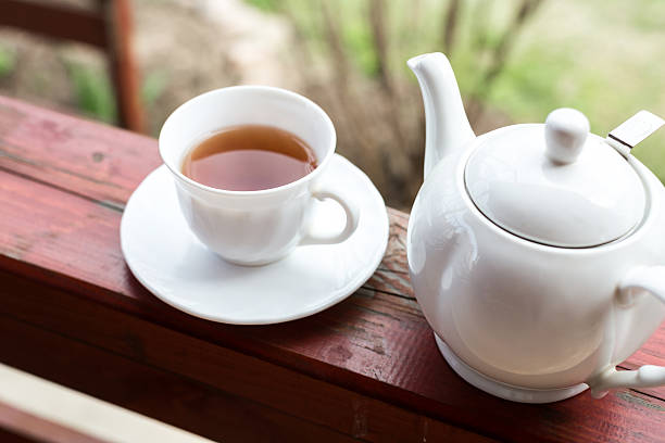 istock Cup of black tea and kettle on veranda 528047076