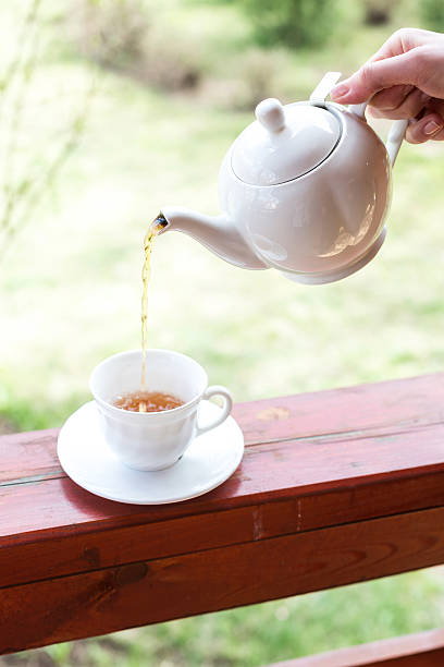 istock Cup of black tea and kettle on veranda 528047278