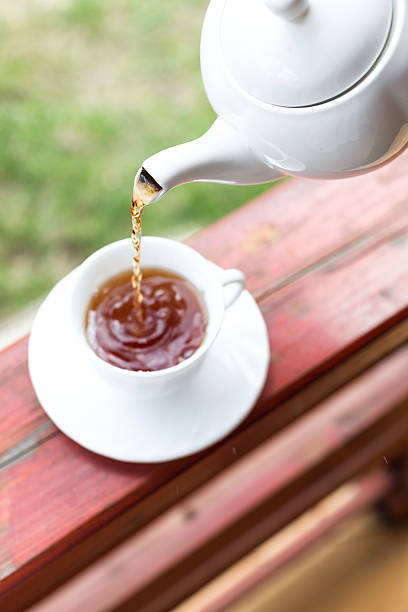 istock Cup of black tea and kettle on veranda 528047330