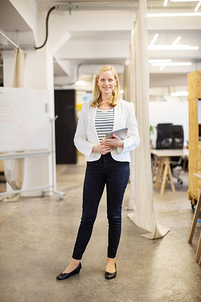 istock Full length of professional holding tablet computer 528047506
