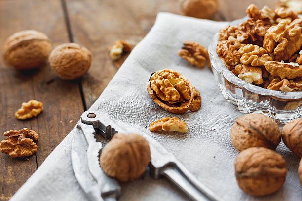 istock Glass bowl with walnuts on rustic homespun napkin. Healthy snack. 528047880