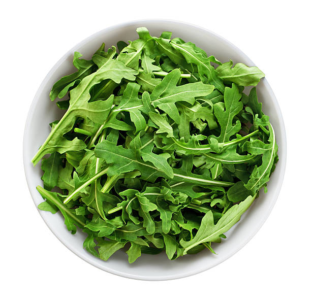 istock Bowl with fresh green salad arugula isolated on white background 528050238