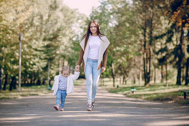 istock young family walking in the park 528051910