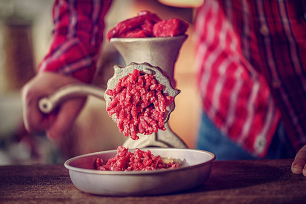 Fresh Minced Meat in a Mincer Fresh minced beef and pork meat in a mincer. grinder stock pictures, royalty-free photos & images