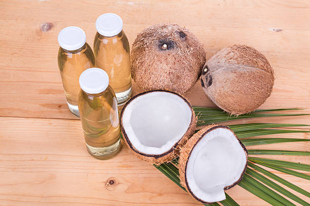 istock Cold pressed extra virgin coconut oil in bottles with coconuts 528052158