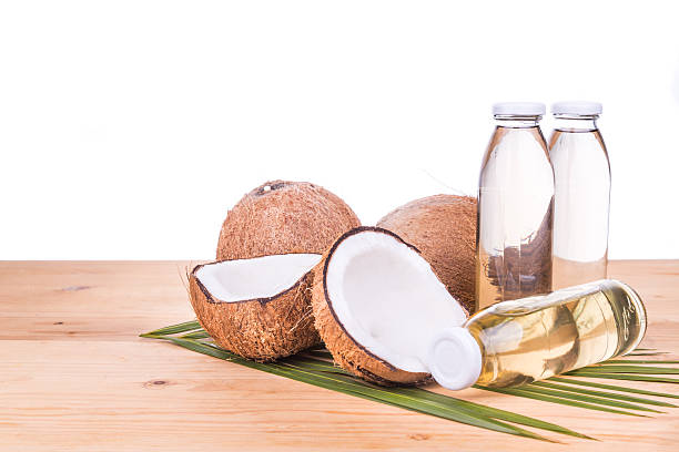 istock Cold pressed extra virgin coconut oil in bottles with coconuts 528052188