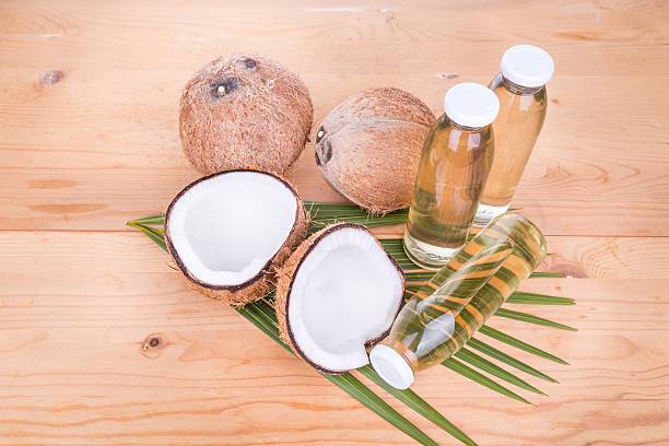 istock Cold pressed extra virgin coconut oil in bottles with coconuts 528052242