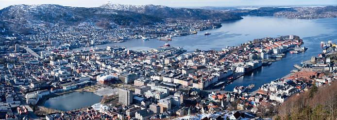 The photo was taken from Floyen (Fløyen). a day n March. The weather is clear and there are snow on the surrounding mountains. The picture is a stitch from several photos..