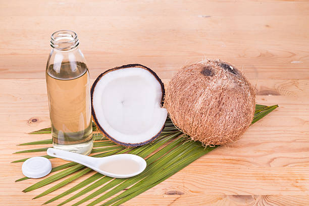 istock Cold pressed extra virgin coconut oil in bottles with coconuts 528052522