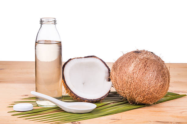 istock Cold pressed extra virgin coconut oil in bottles with coconuts 528052558