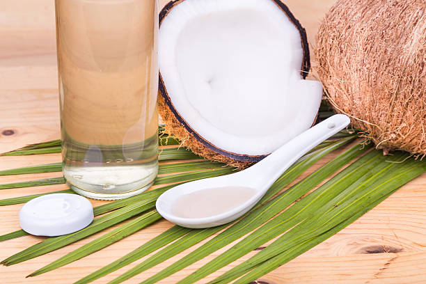 istock Cold pressed extra virgin coconut oil in bottles with coconuts 528052610