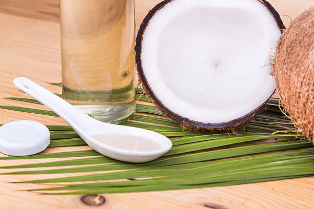 istock Cold pressed extra virgin coconut oil in bottles with coconuts 528052658